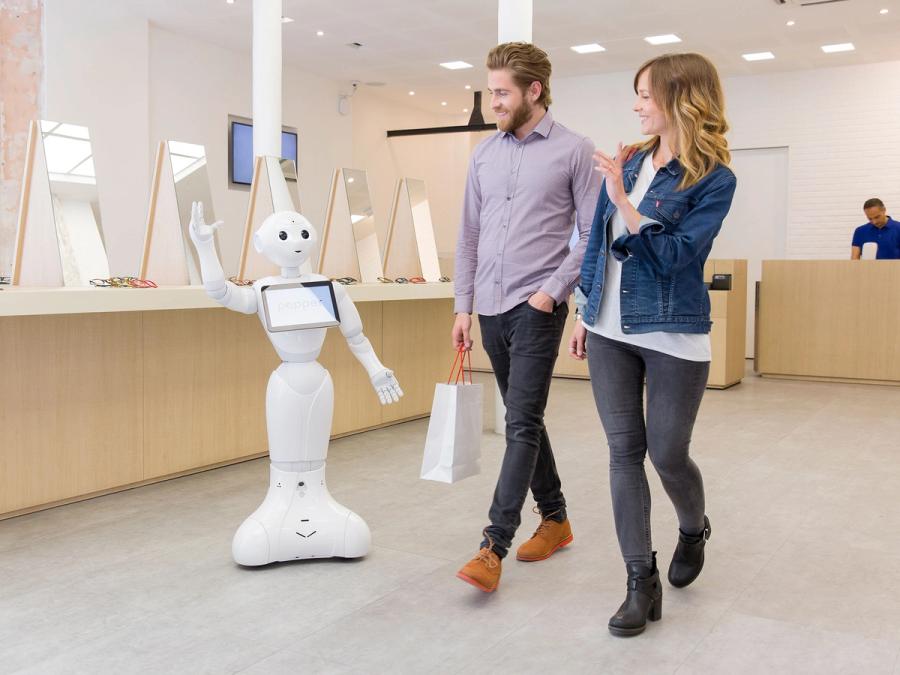 Pepper is seen waving at customers as they leave a store.