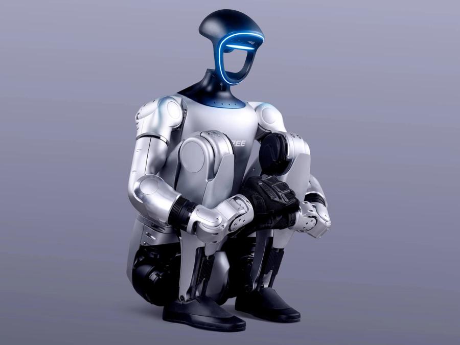 Unitree Robotics' G1 bipedal humanoid robot squats down all the way with it's torso flush to it's legs, and arms wrapped around legs.