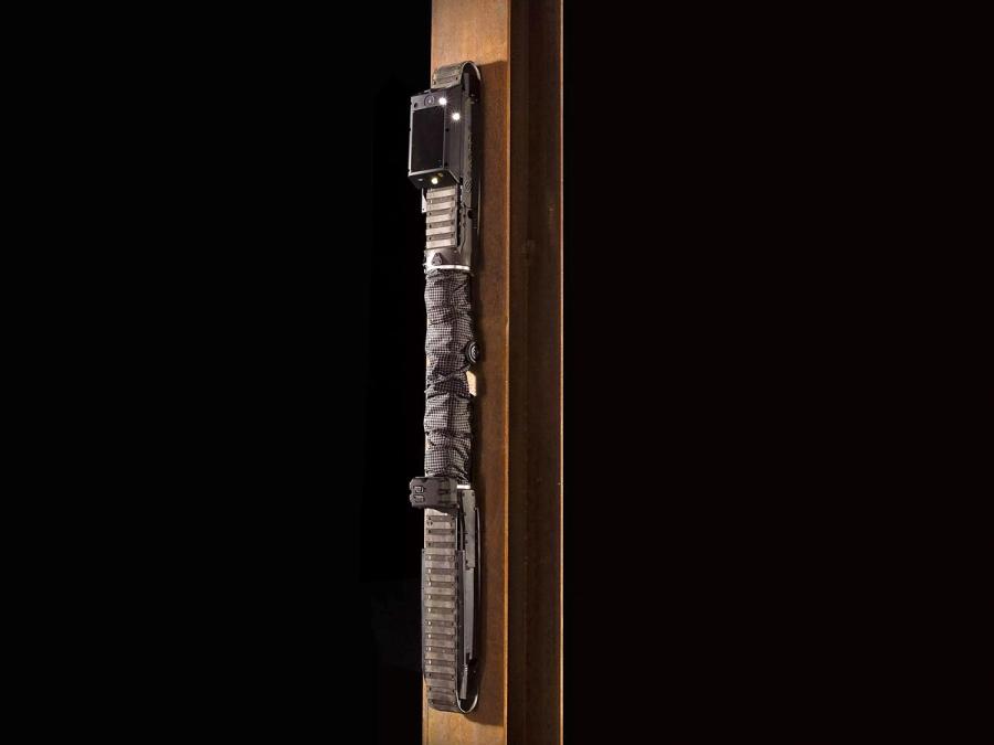 The snake robot is completely vertical as it moves up a wall.