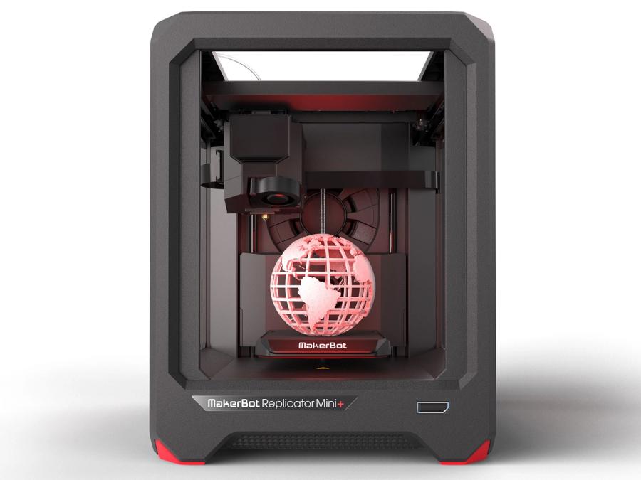 A smaller black rectangle box with a pink globe that has been 3D printed.