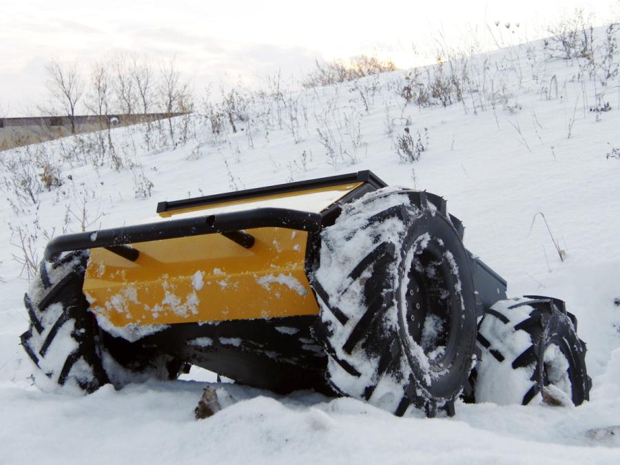The robot is coated in and surrounded by snow.