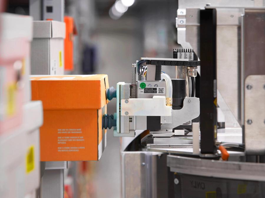 Close-up of suction cups on a telescoping lens that are attached to a shoe box, which is being pulled off a shelf.