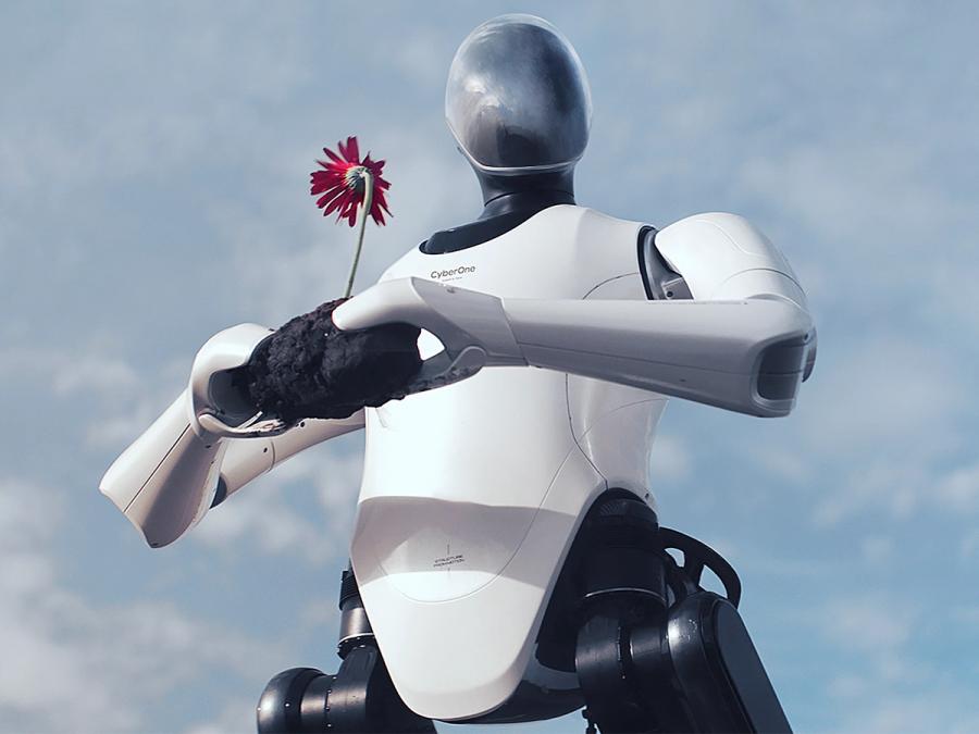 An image from below of a CyberOne humanoid robot holding a piece of coal with a red flower.